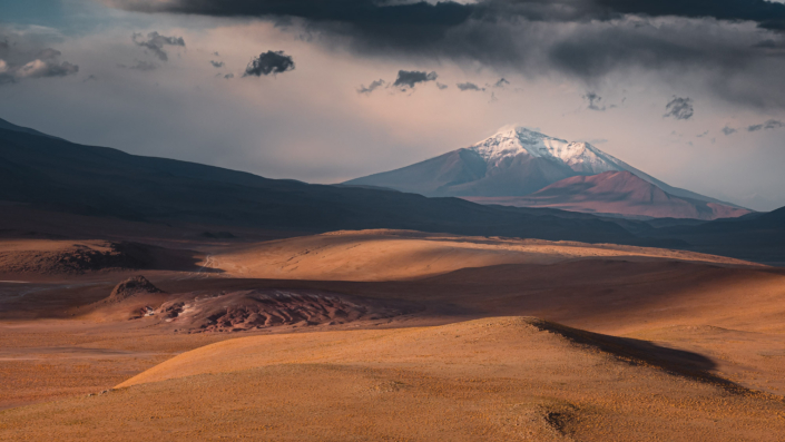 salt flat bolivia volcano with snow sunset
