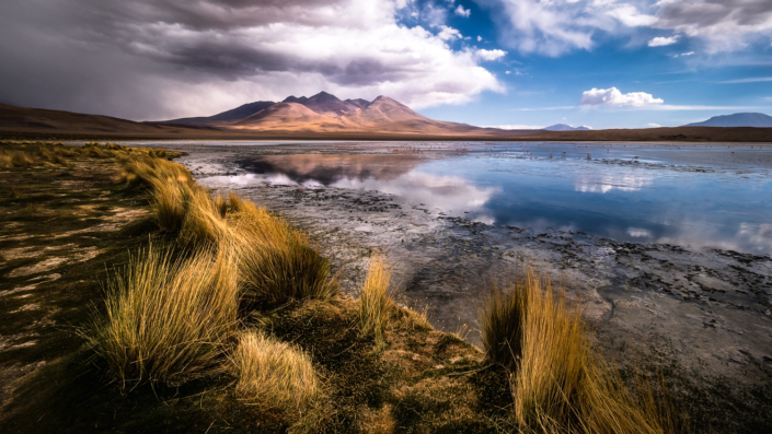 salt flat bolivia volcano with snow sunset